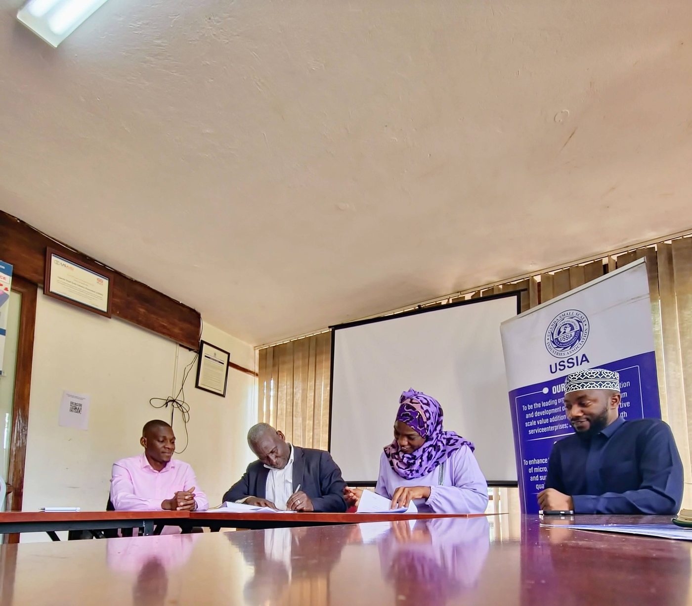 UHB and USSIA principals signing the MOU at the table