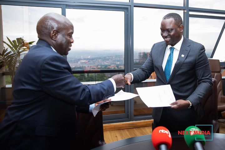 Bureau officials shaking hands at a formal press engagement