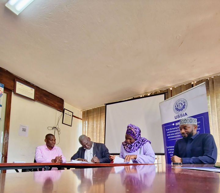 UHB and USSIA principals signing the MOU at the table
